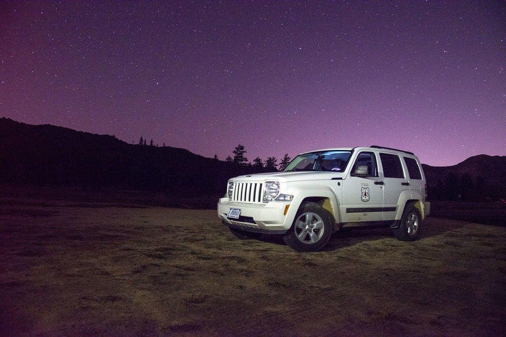 Starry night sky above a dark landscape