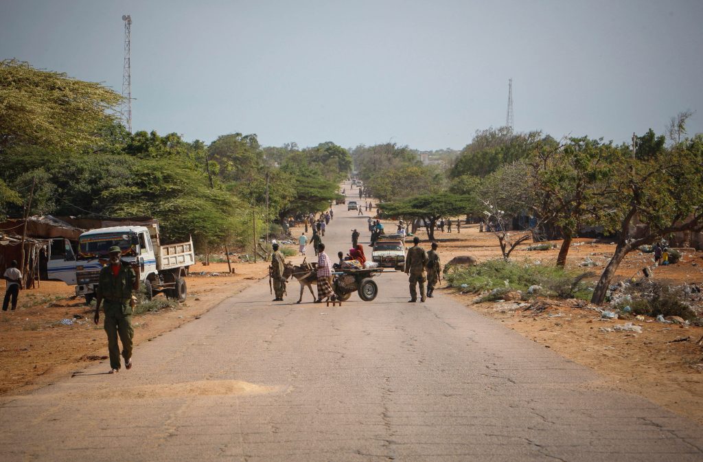 Combat engineers searching for improvised explosive devices on an urban street