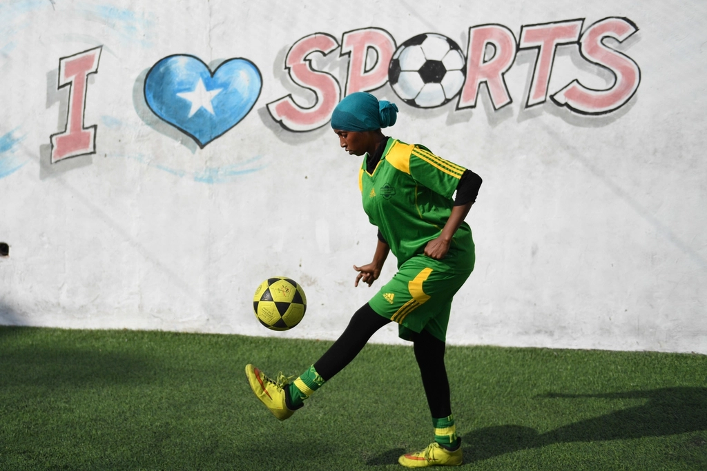 Football player dribbling the ball during a match